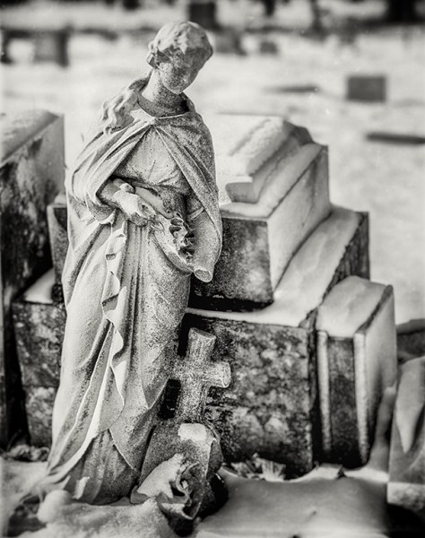 leaning statue in the snowa